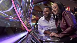 Live dealer blackjack table with mobile app interface overlay showing promotional tier indicators